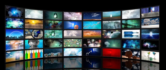 Several rows of bright TFT LCD display screens on a wall.