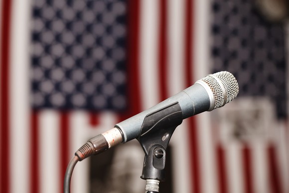 Microphone in front of two American flags