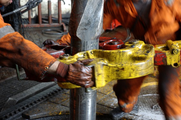 Oil field service workers on a rig.
