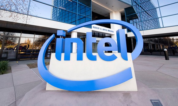 Intel's iconic logo in the form of a large, blue statue in front of abuilding on the company's HQ campus.