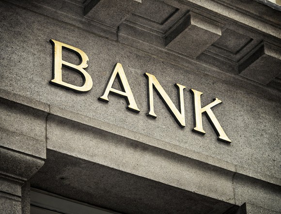 Letters spelling out "BANK" on a stone building