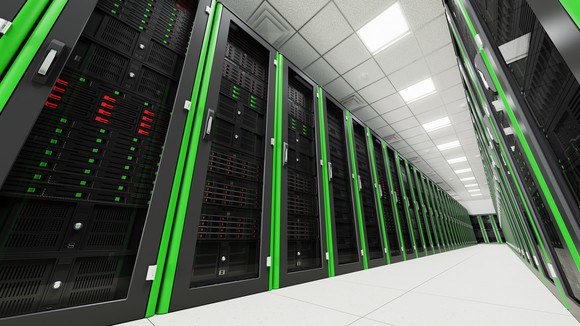 Dramatic off-kilter angle shot of a data center corridor, decked out in bright green accents.