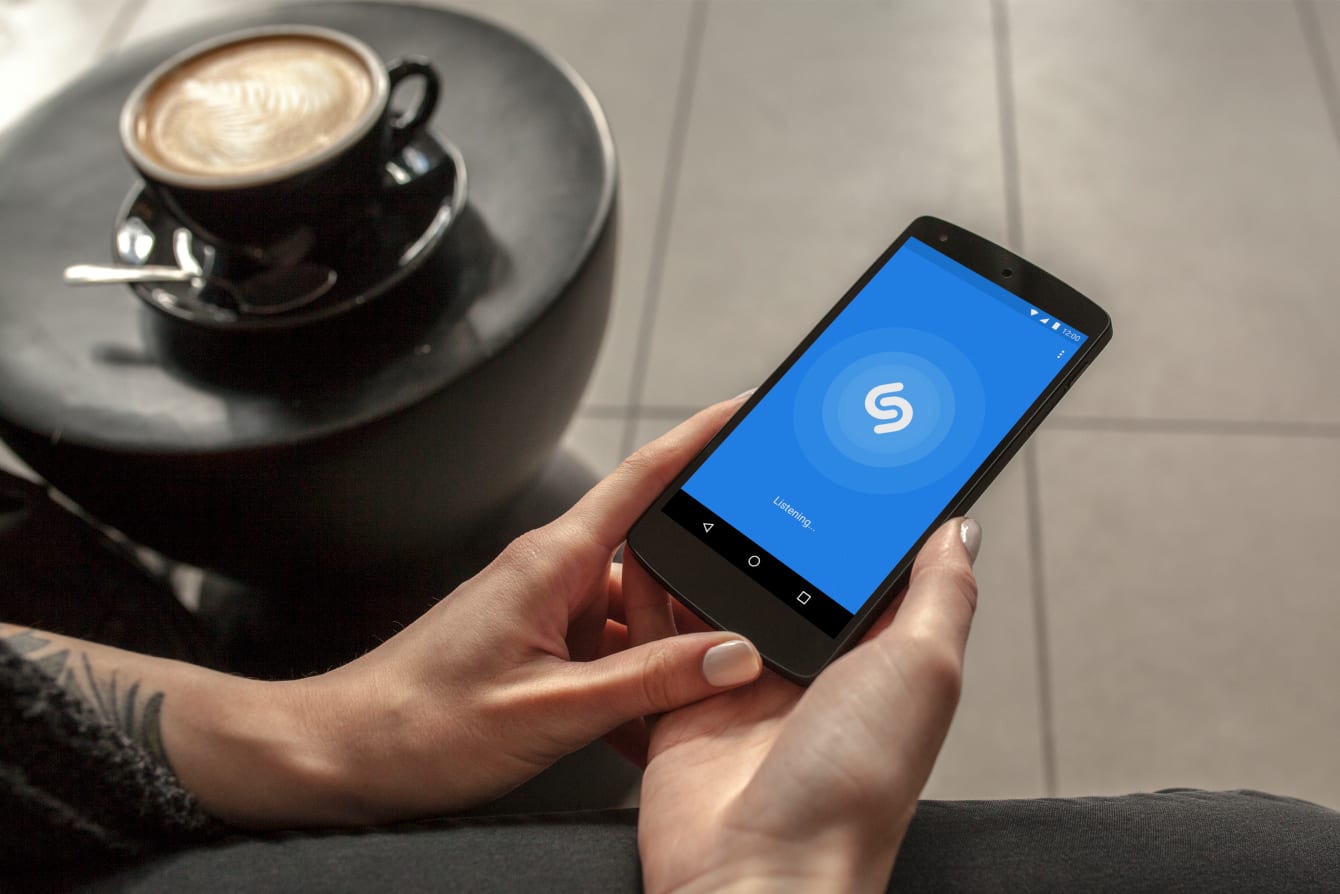Person using Shazam on a smartphone