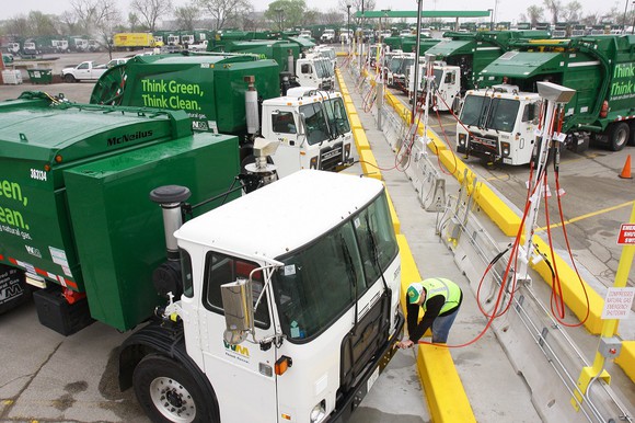 Waste management trucks refueling with CNG.