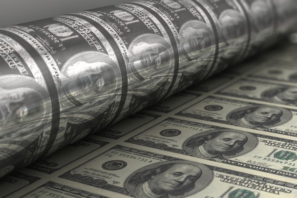 A printing press printing hundred dollar bills.