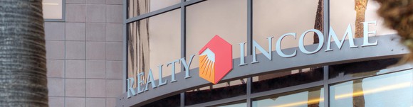Awning with Realty Income logo on commercial building.