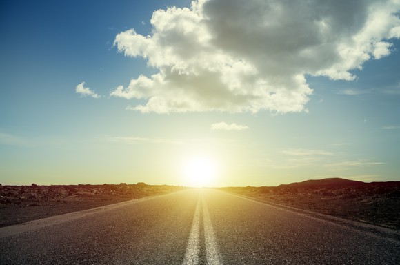Sun setting over a road.