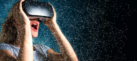 A woman wearing a VR headset surrounded by stars.
