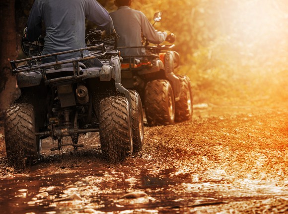 ATVs on a muddy road