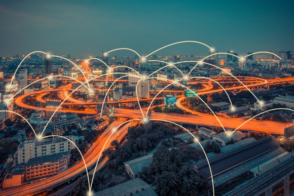 Cityscape with long-exposure traffic image and points connected by arched lines