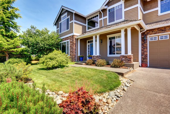 House with large driveway and lawn