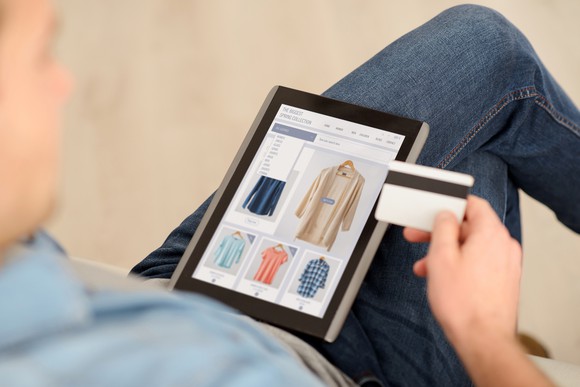 view of tablet held by man making an online purchase.