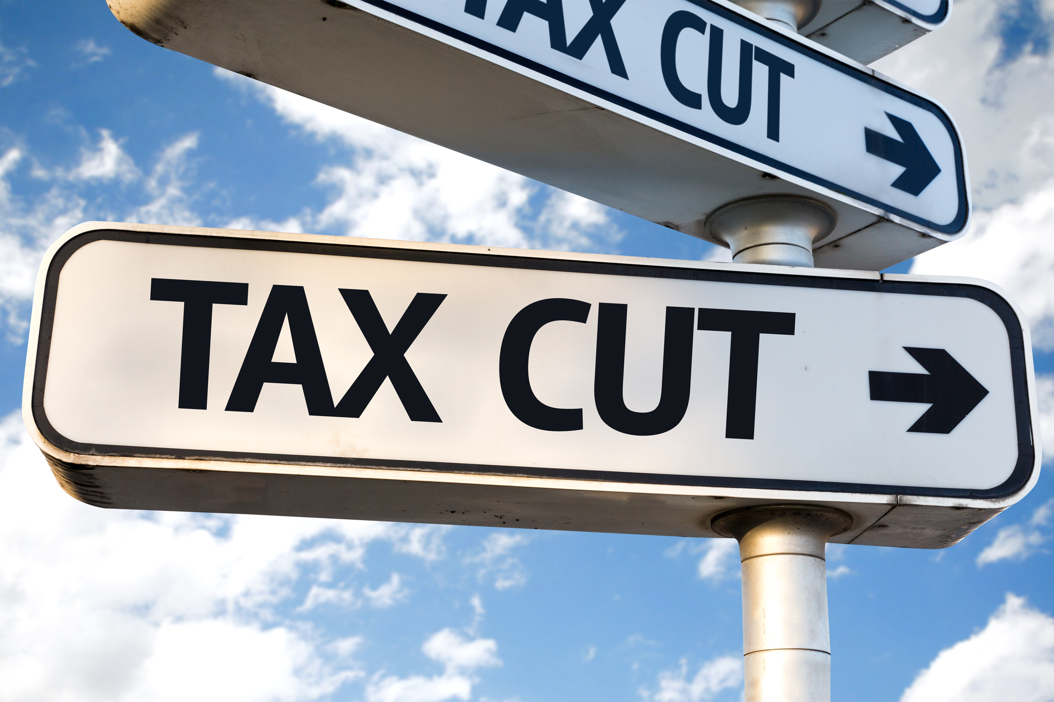 A sign labeled tax cut followed by an arrow