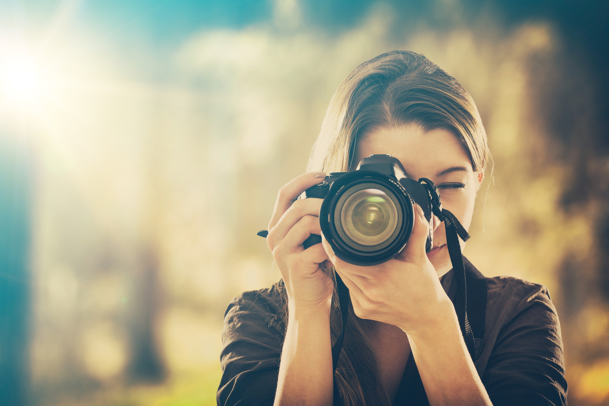 Woman taking a picture with a camera.