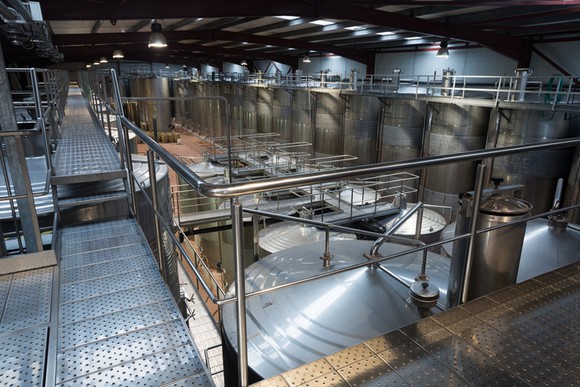 Metal catwalks overlooking vats at a small bio-manufacturing facility.