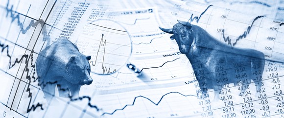 Bull and bear superimposed on stock graphs.