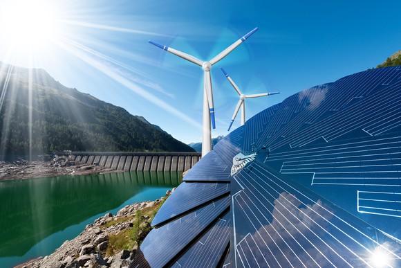 Solar panels and wind turbines near a hydropower plant.