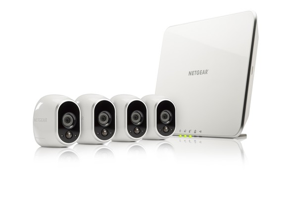Netgear Arlo security cameras and router against a white background.