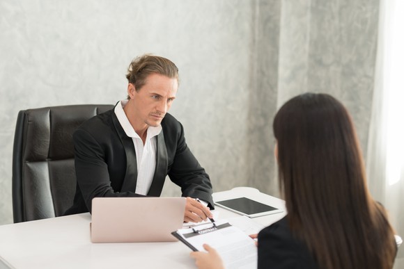 Professional male and female sitting across from each other