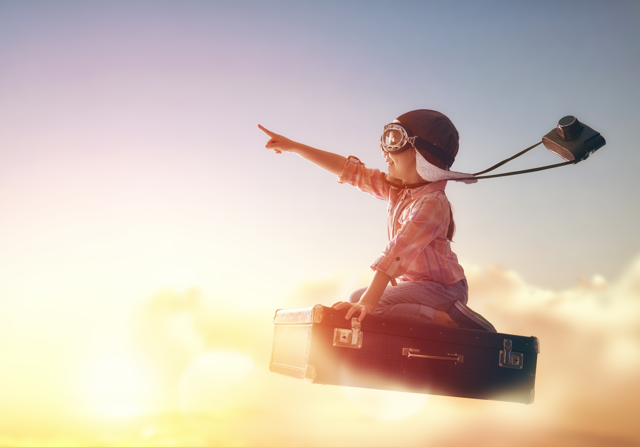 A rocket soaring into the sky with a little girl riding it who is pointing upward.