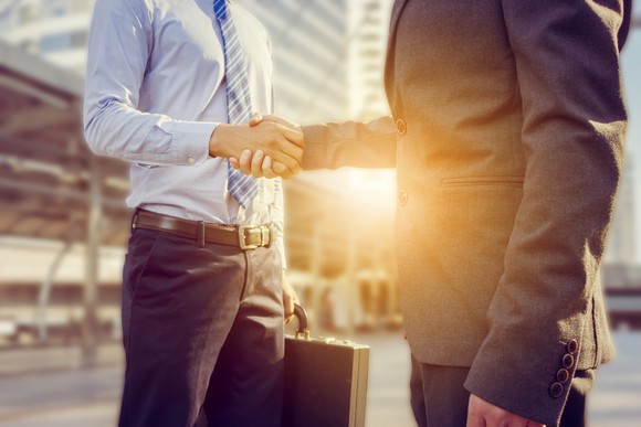 Two businessmen shake hands.