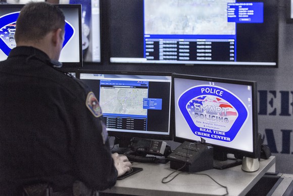 Law enforcement officer at a computer station.