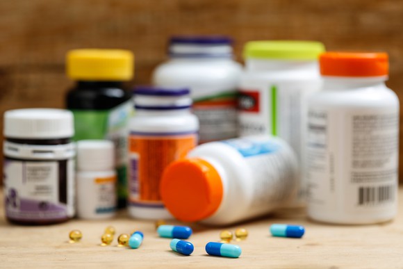 Scattered pill bottles and pills.
