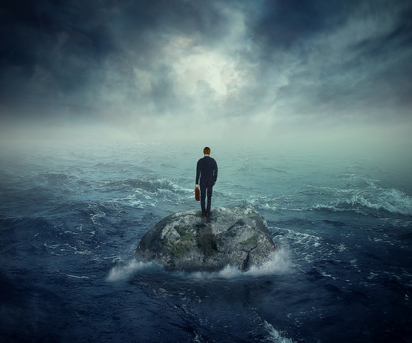 a man standing on an island in the middle of a raging storm