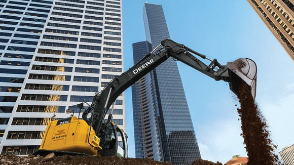 A John Deere equipment on a high-rise construction site.