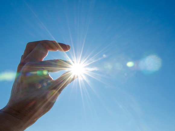 Sun between fingertips