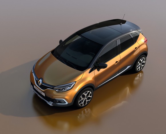 A bronze-and-black Renault Captur, a small SUV, viewed from above.