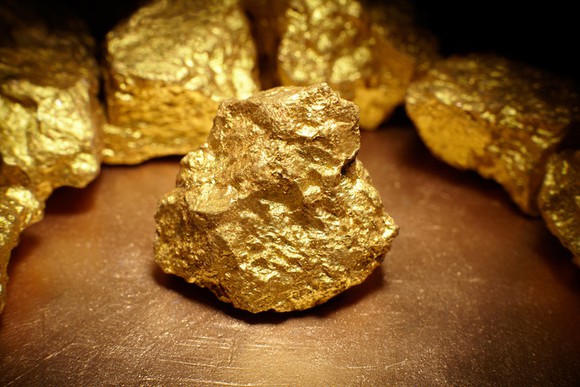 Gold nuggets sitting on a table.