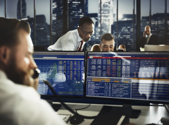 Stock traders looking at computer screens