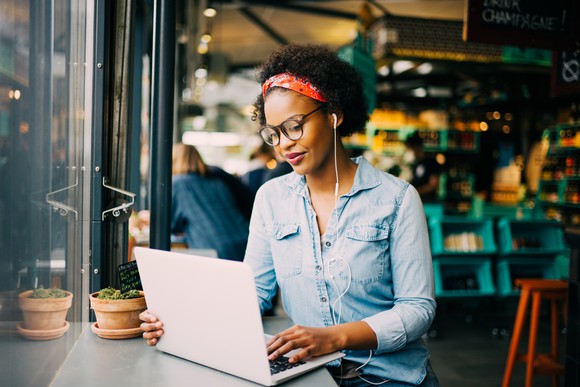 Woman types on laptop.