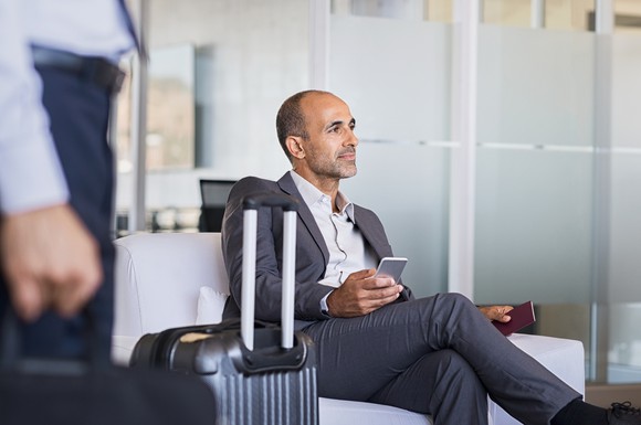 Businessman using a smartphone at an airport