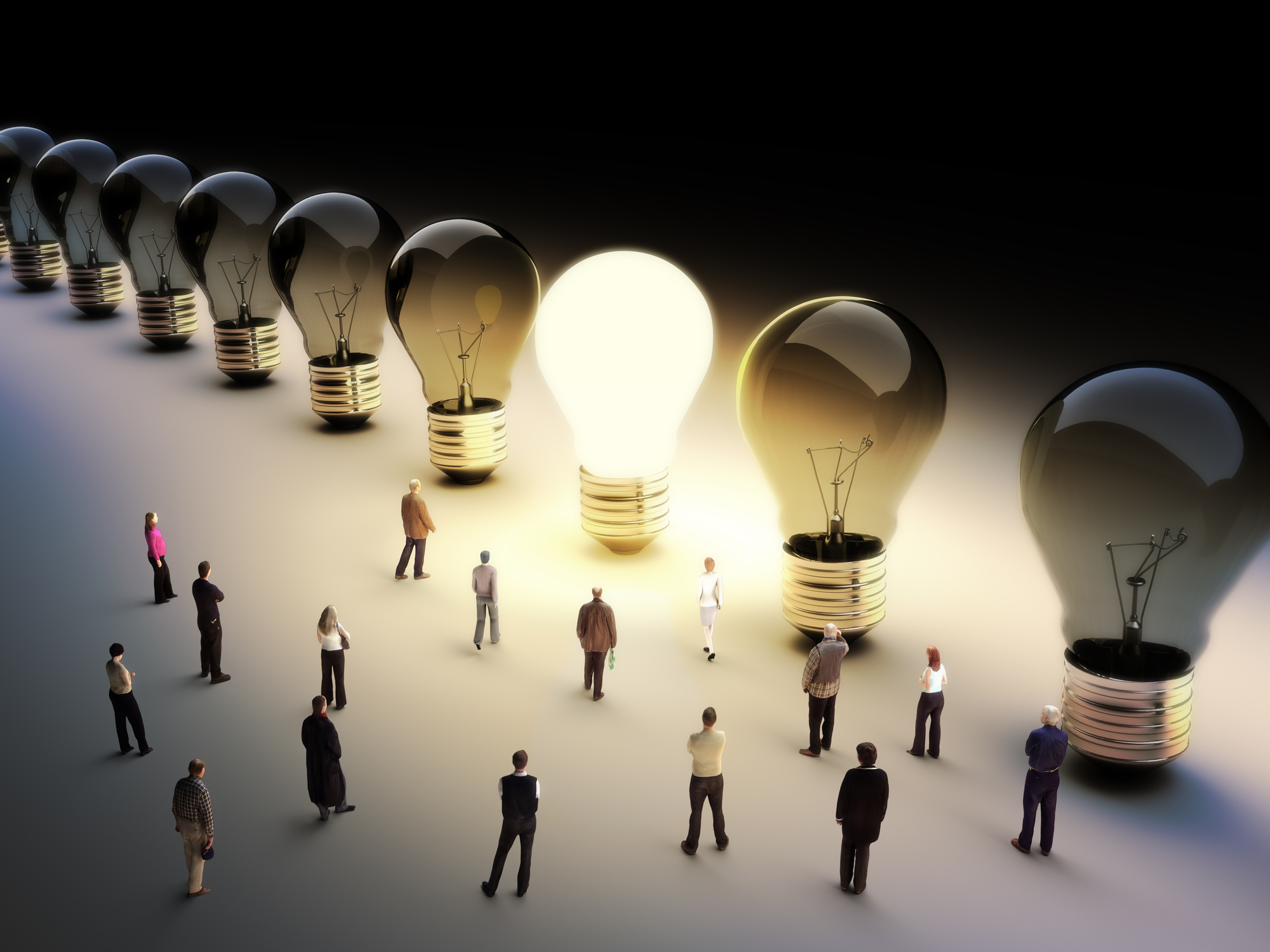 People standing around giant light bulbs -- seven are burnt out and one is lit up