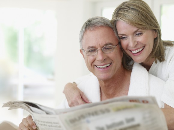 Older couple reading a newspaper
