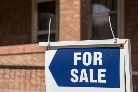 For sale sign in front of a building.