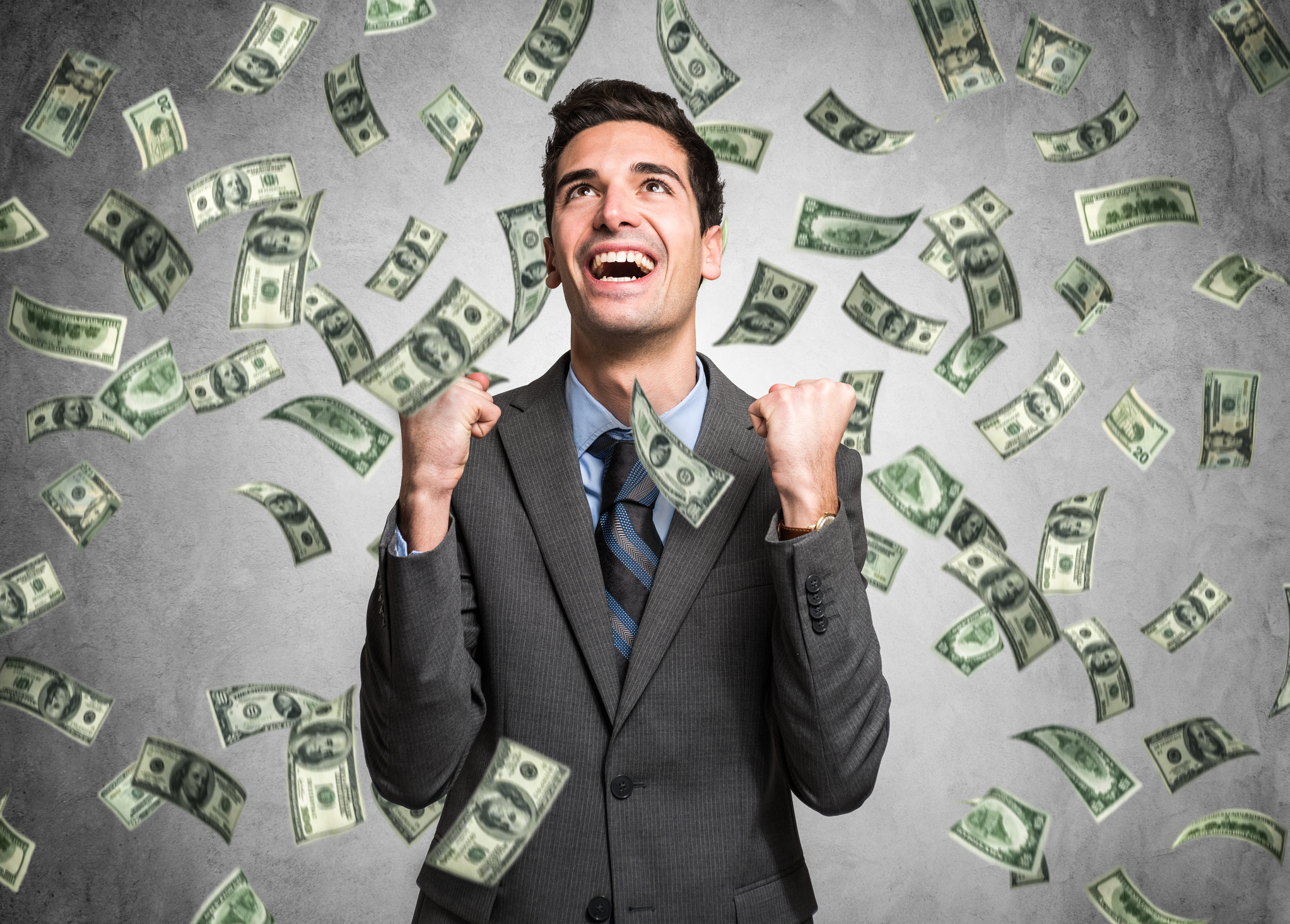 A happy man surrounded by money.