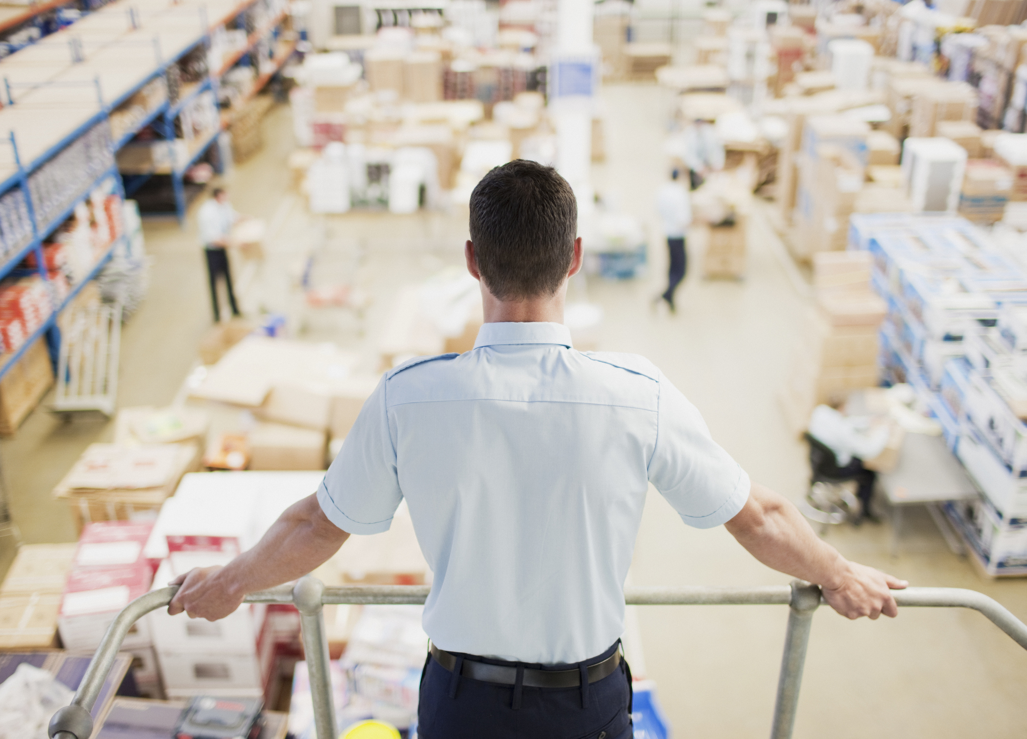 Man looks over a warehouse.