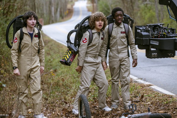 Three young boys in Ghostbusters costumes, in a scene from Netflix's "Stranger Things 2".