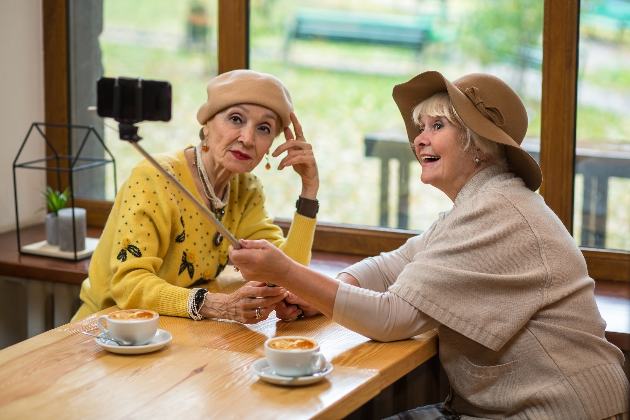Two elderly women taking a selfie.