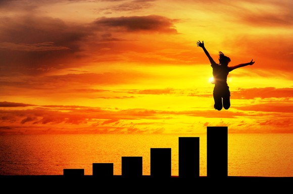 A person jumps in the air off the highest bar in an ascending bar chart.