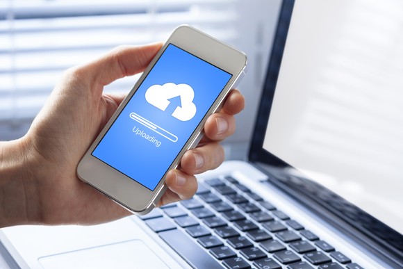 A smartphone uploading data to cloud storage