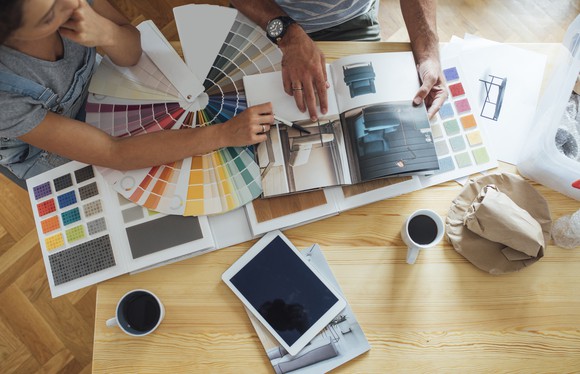 Couple looking at paint samples and other remodeling materials.