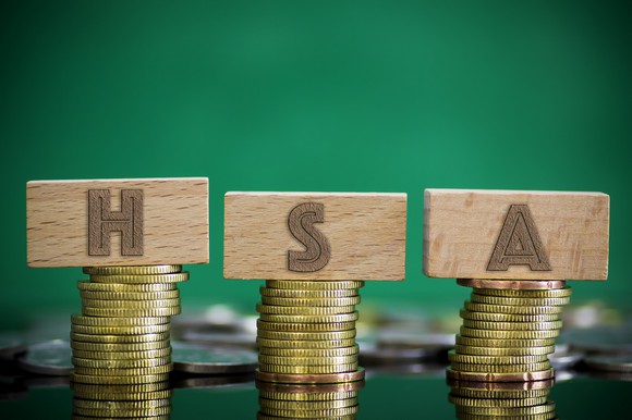 Piles of coins with letters HSA on top of them.