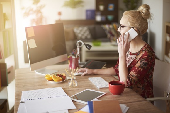 Woman at a desk talking on the phone