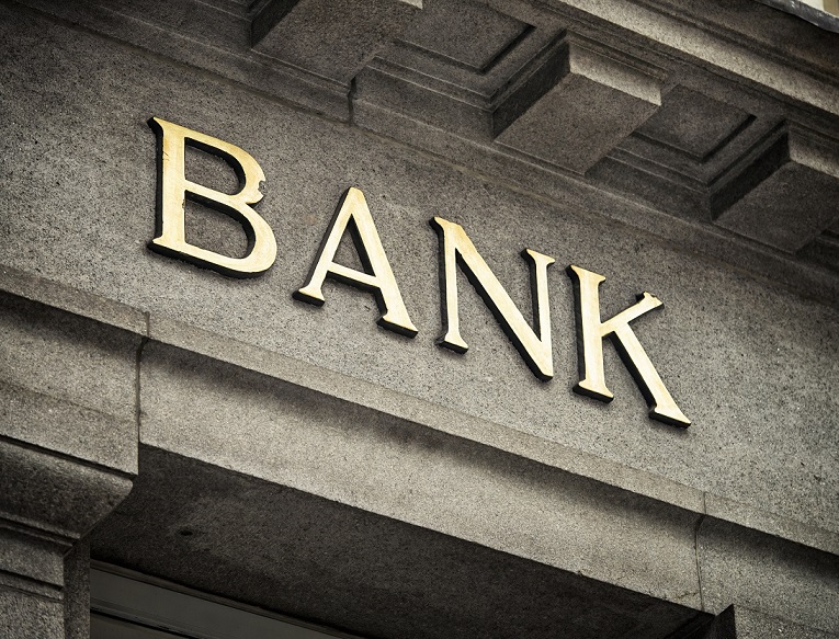 Bank sign on stone building.