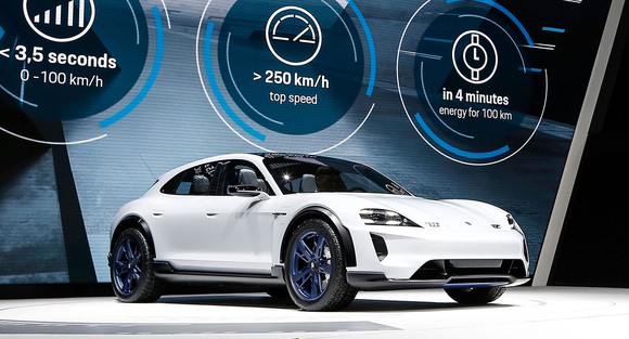 The Porsche Mission E Cross Turismo, a low-slung white SUV, on Porsche's show stand at the Geneva International Motor Show in March 2018.
