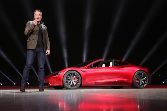 Elon Musk standing in front of the new Roadster